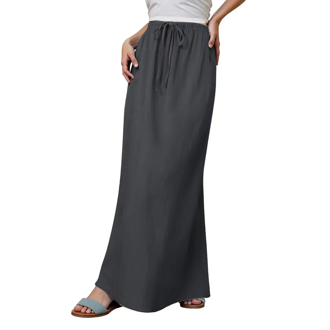 Woman wearing a charcoal gray drawstring waist maxi skirt with pockets and light blue sandals