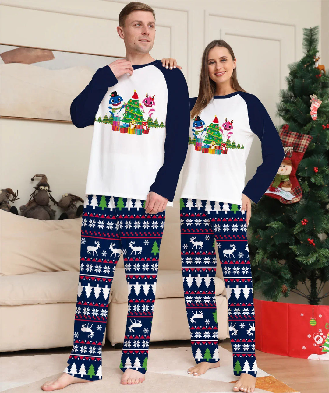 Couple wearing matching Christmas pajamas with festive monsters, Christmas tree, and reindeer patterns