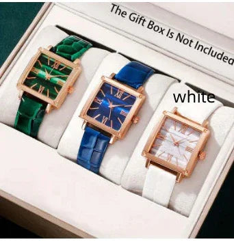 Set of three elegant square dial wristwatches with green, blue, and white leather straps in a white box