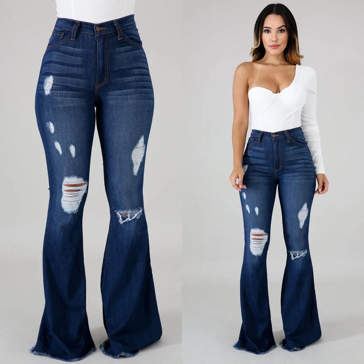 woman wearing high-waisted distressed dark blue flared jeans with one-shoulder white top