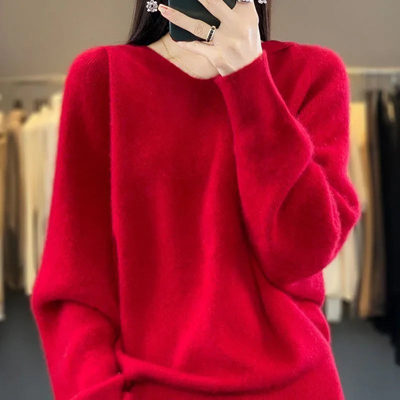 Woman wearing a bright red fuzzy oversized sweater in a clothing store mirror selfie