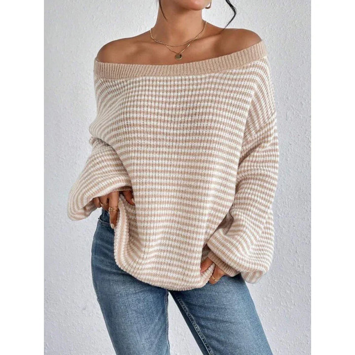 Woman wearing beige and white striped off-shoulder sweater with balloon sleeves and blue jeans