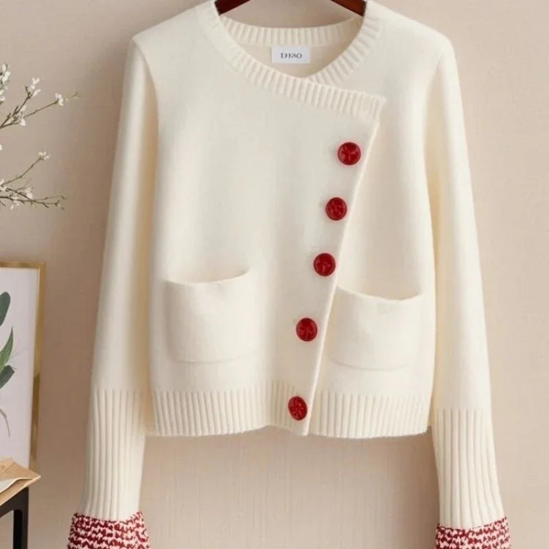 Cream white knit cardigan with red buttons and red patterned cuffs, two front pockets