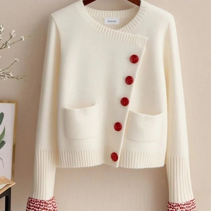 Cream white knit cardigan with red buttons and red patterned cuffs, two front pockets