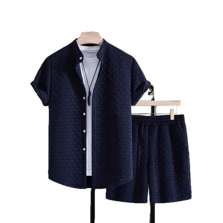 Navy blue textured short-sleeve shirt and matching shorts set with white inner shirt on wooden hangers