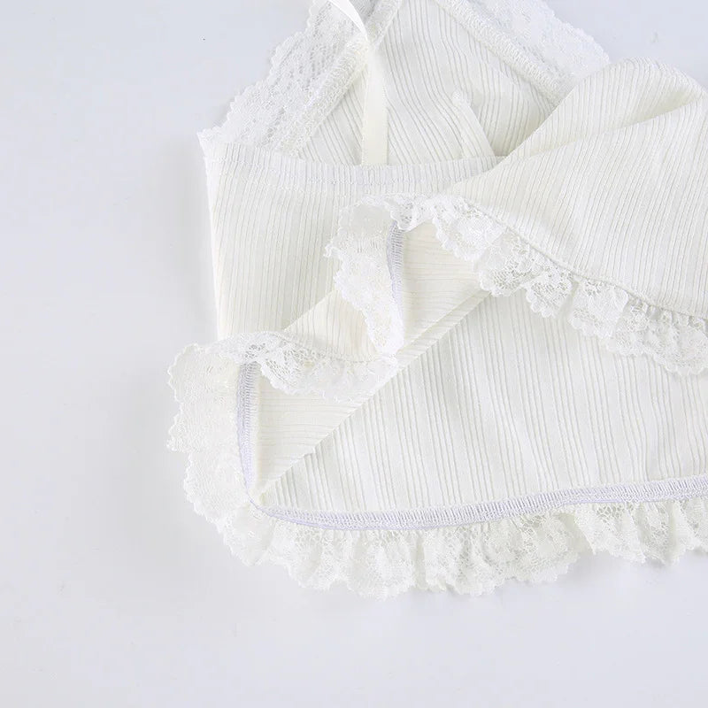 White ribbed fabric with delicate lace trim on soft textile, detailed close-up