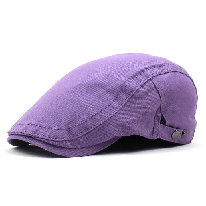 Purple cotton flat cap with metal side button detail on white background