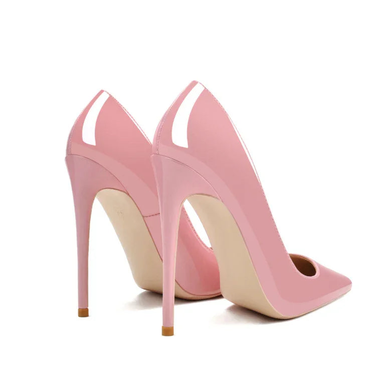 Pair of glossy pink high-heel stiletto shoes with pointed toes on white background