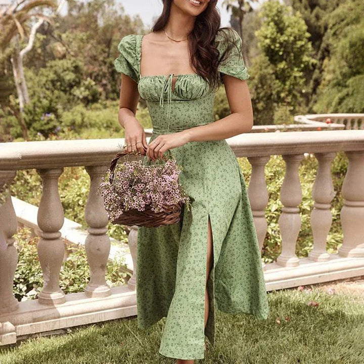Woman in green floral midi dress with puff sleeves holding basket of pink flowers outdoors