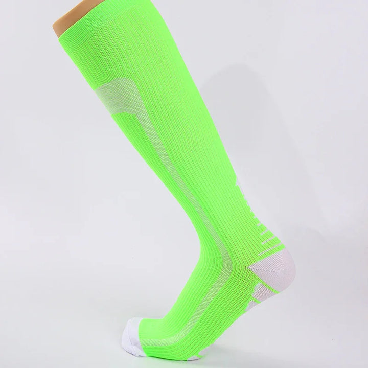 Bright green knee-high compression sock with white toe and heel accents on mannequin leg