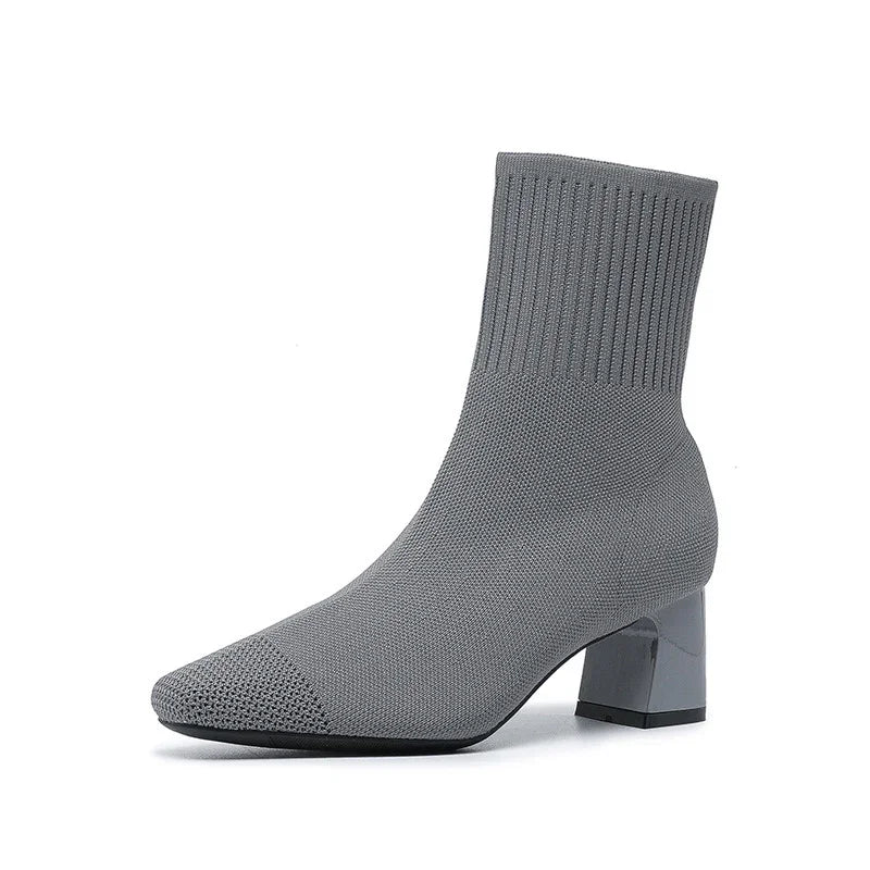 Gray knit sock boot with block heel and textured toe on white background
