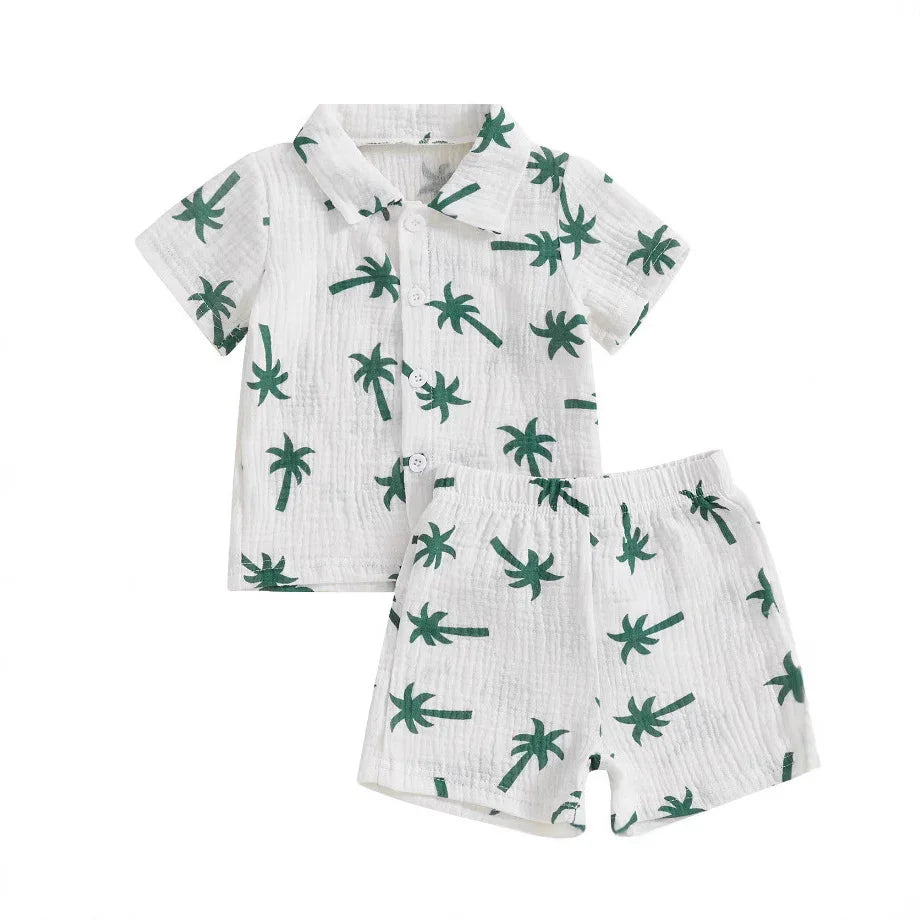 White toddler shirt and shorts set with green palm tree print, short sleeves and buttons