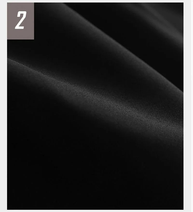 Close-up of smooth black fabric with subtle folds, labeled number 2 in corner