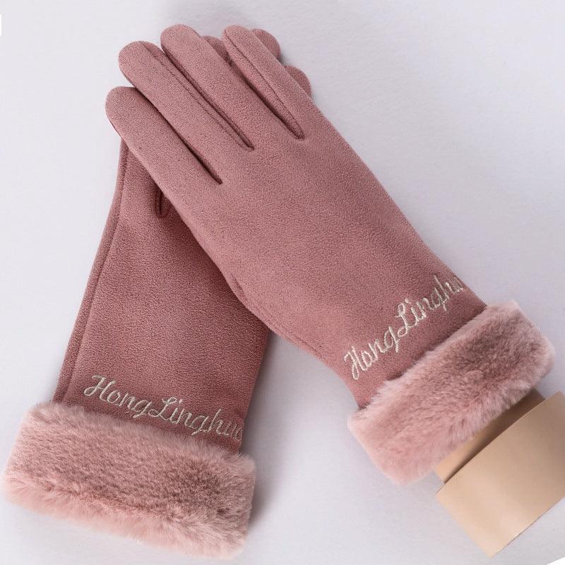 Pair of soft pink winter gloves with faux fur cuffs and embroidered script on a white background