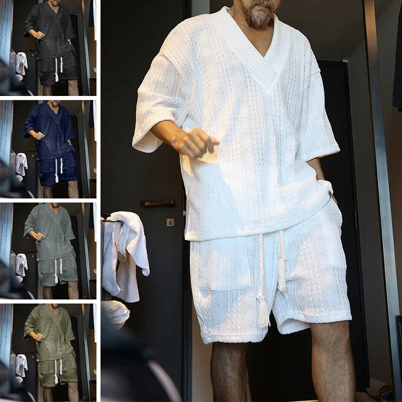 Man wearing textured knit V-neck shirt and matching shorts in white, black, navy, gray, and olive colors