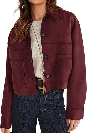 Woman wearing a burgundy button-up suede jacket with large pockets, paired with white top and dark jeans