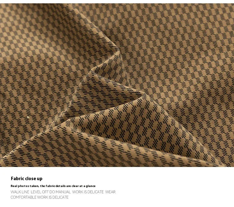 Close-up of brown fabric with fine diagonal black pattern, soft texture with folds