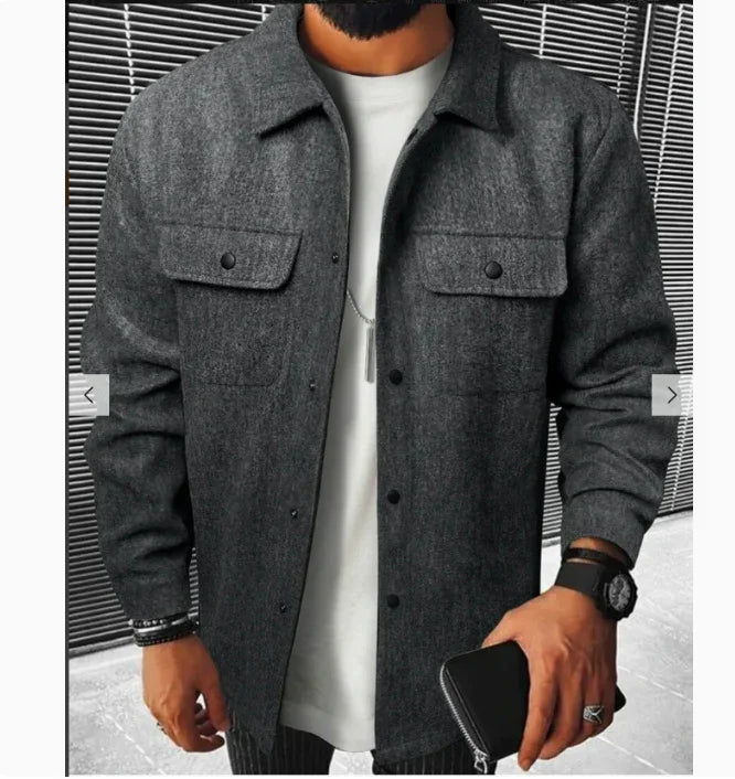 Man wearing a dark gray wool button-up jacket over a white shirt, holding a black wallet and wearing a watch