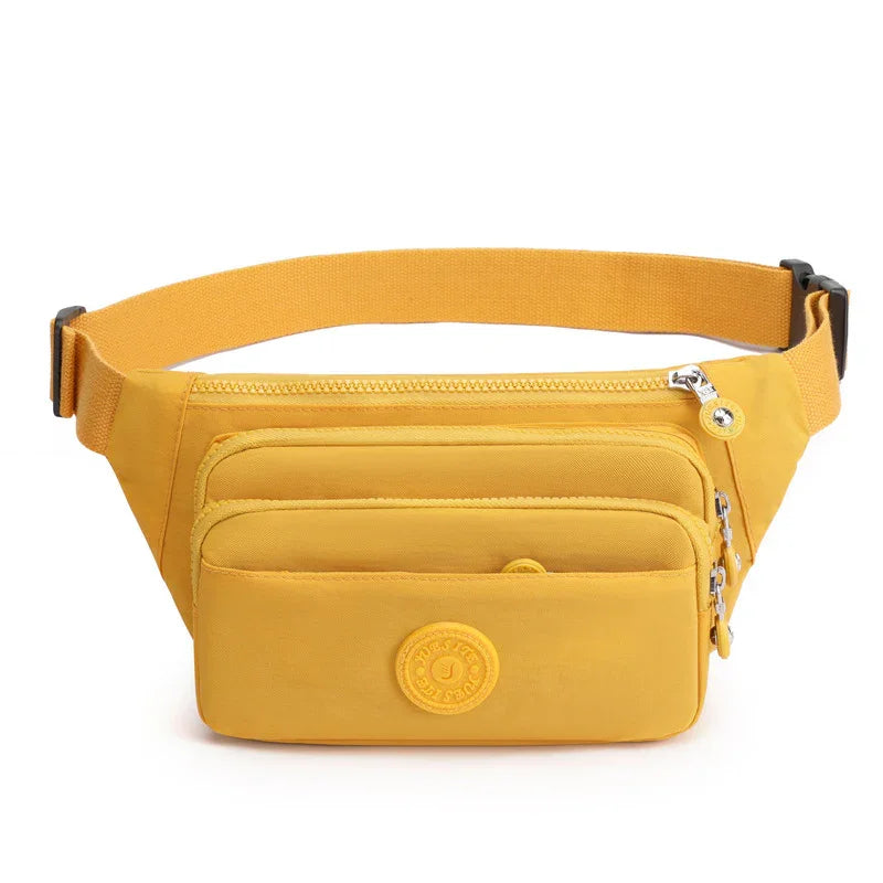 Yellow multi-pocket waist bag with adjustable strap and zipper closures on white background