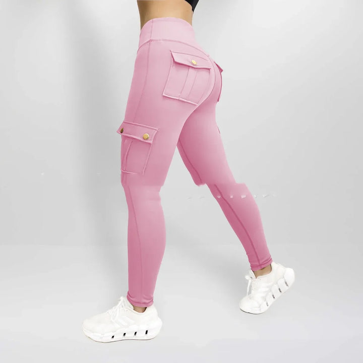 Woman wearing pink cargo active leggings with flap pockets and white athletic sneakers