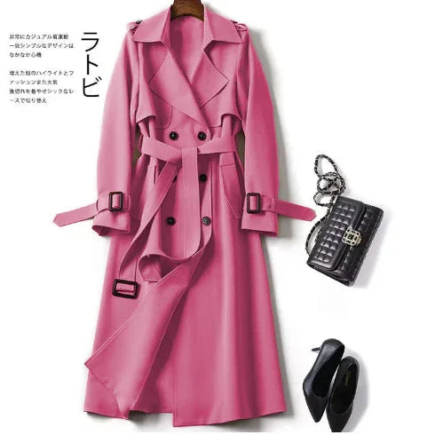 Stylish pink trench coat with belt, paired with black quilted handbag and black high heels on white background