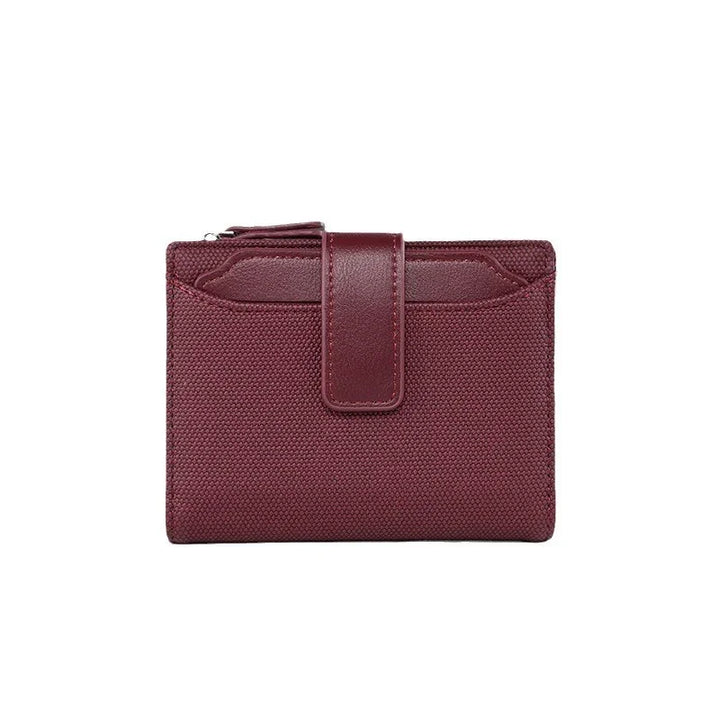 Burgundy textured wallet with leather strap and zipper pocket on white background