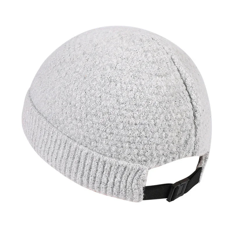 Gray textured knit beanie hat with adjustable black strap on white background