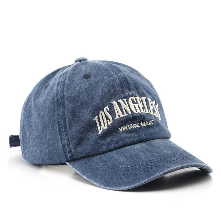 Blue vintage-style baseball cap with white embroidered text 'Los Angeles Vintage Made'