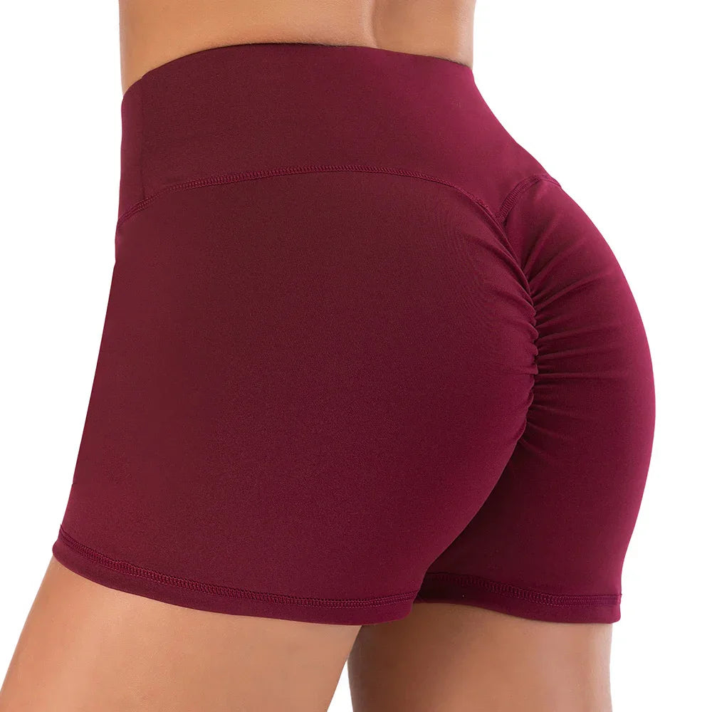 close-up of woman wearing high-waisted maroon ruched yoga shorts