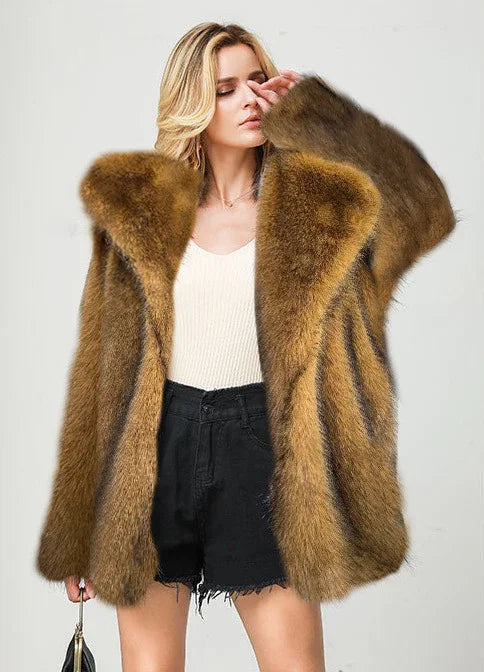 blonde woman wearing oversized brown fur coat with black shorts and white top against plain background