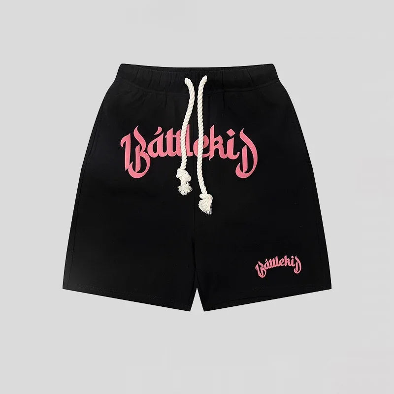 Black shorts with pink Battlekid logo and white drawstring, streetwear style