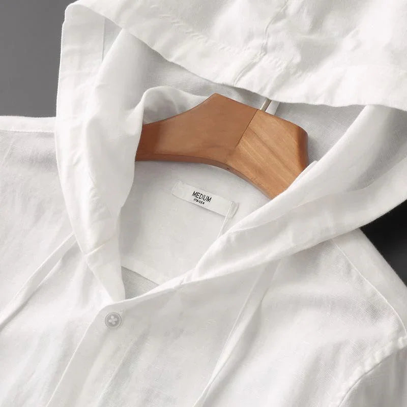 White medium-sized linen hoodie on a wooden hanger with a close-up of the collar and button