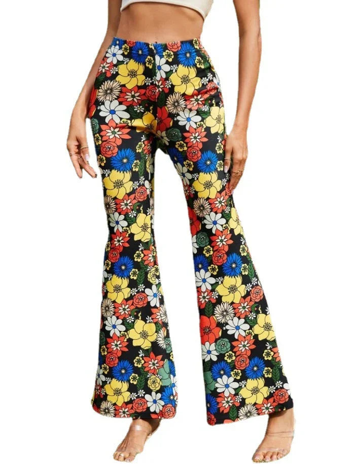 Woman wearing vibrant high-waisted floral print bell-bottom pants with colorful flowers