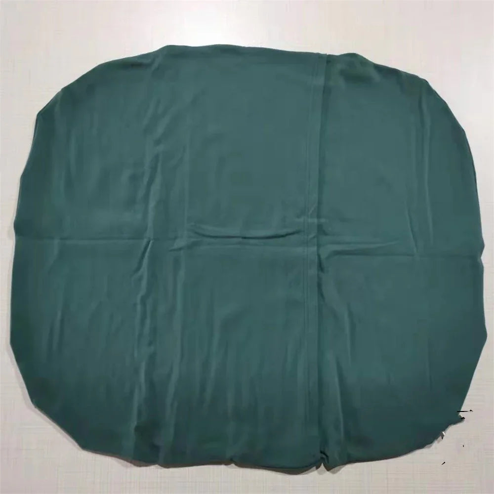 Dark green rounded fabric cover laid flat on white surface with visible creases