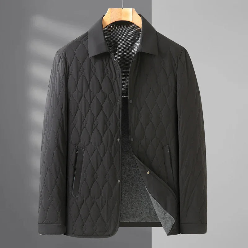 Black quilted men's jacket with diamond stitching and snap button closure on wooden hanger