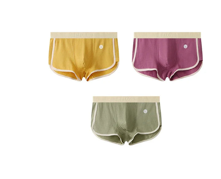 Set of three men's ribbed boxer briefs in yellow, purple, and olive green with beige elastic waistbands