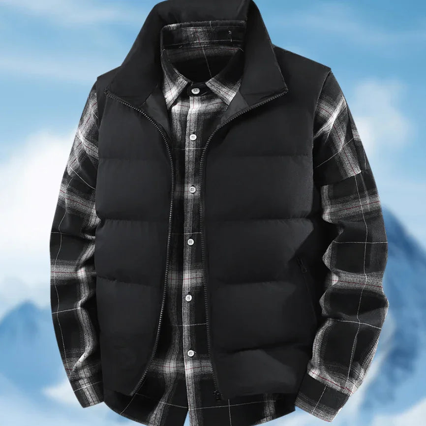 Black puffer vest layered over black and white plaid flannel shirt against sky background