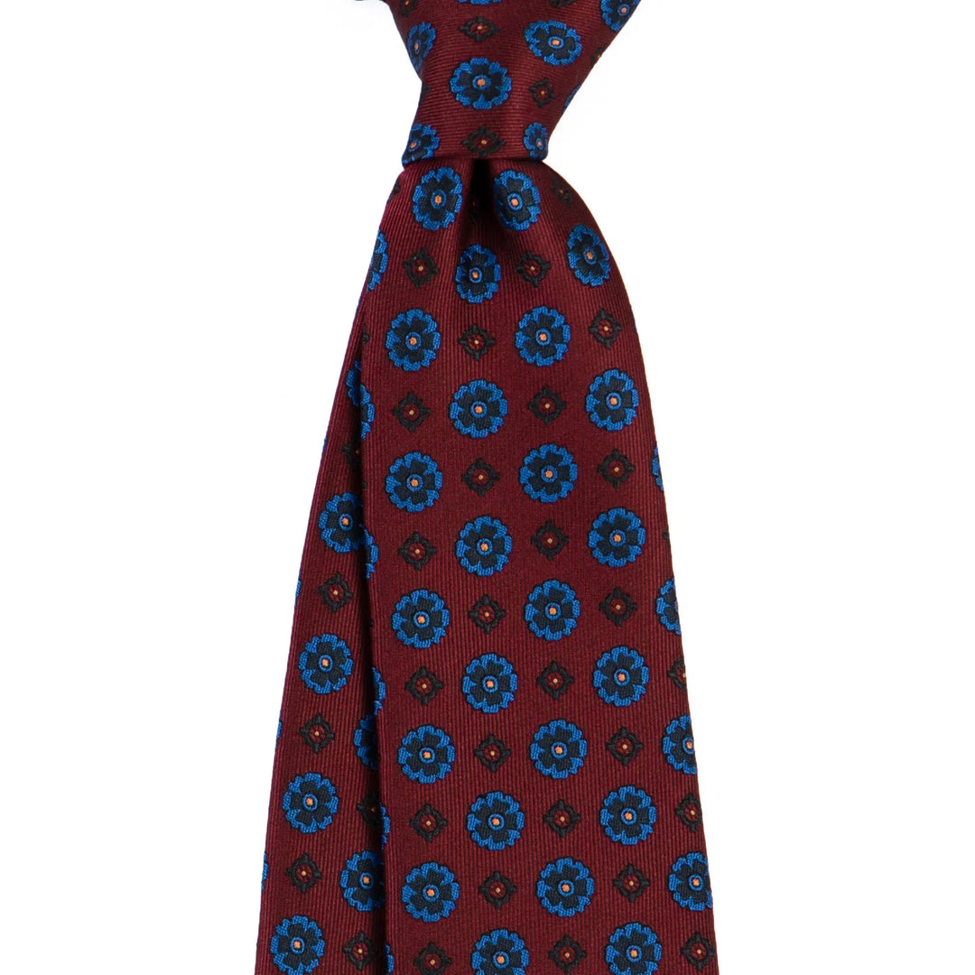 Maroon silk tie with blue floral and geometric pattern, classic men's formal accessory