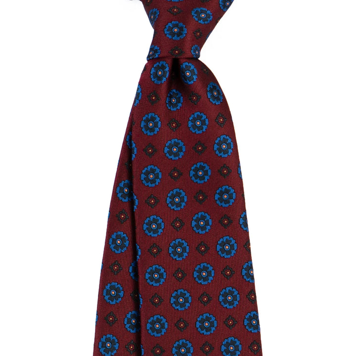 Maroon silk tie with blue floral and geometric pattern, classic men's formal accessory