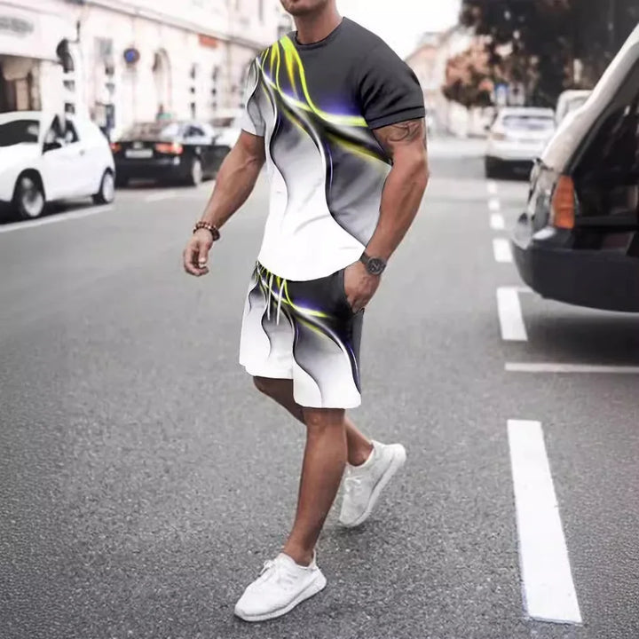 Man wearing black, white, and neon yellow abstract print shorts and t-shirt walking on urban street