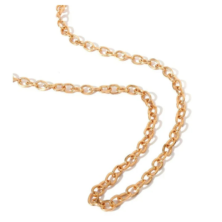 close-up of a gold metal chain with interconnected oval links on white background