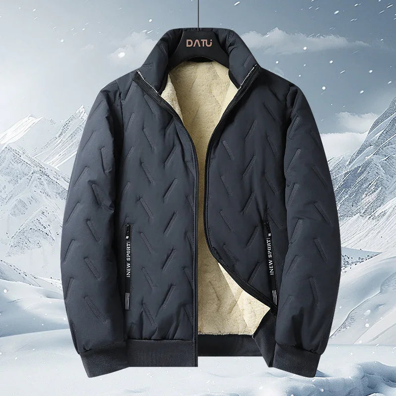 Black insulated winter jacket with fleece lining and zippered pockets against snowy mountain background