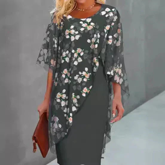 Woman wearing dark floral sheer layered dress with half sleeves, holding brown clutch bag