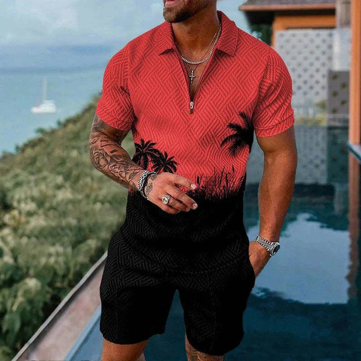 man wearing red and black tropical palm tree print shirt and matching shorts by poolside with ocean view
