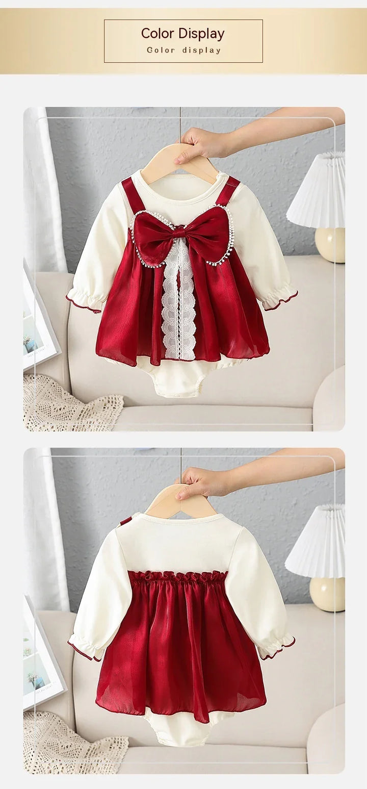 Red and white baby dress with large bow and lace details, shown front and back on hanger