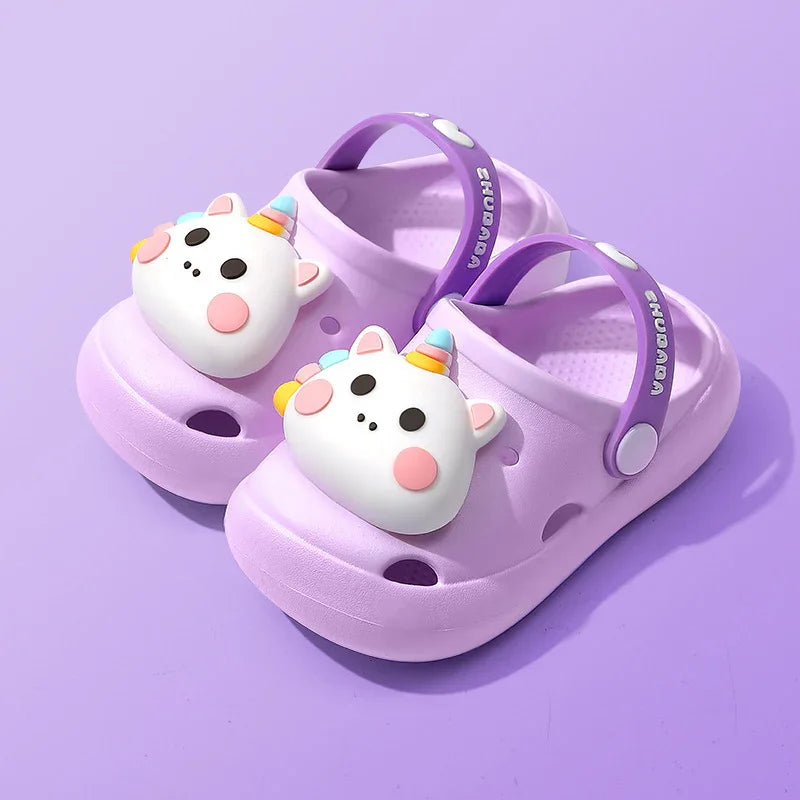 Purple kids clogs with cute unicorn face decoration and adjustable heel strap on purple background