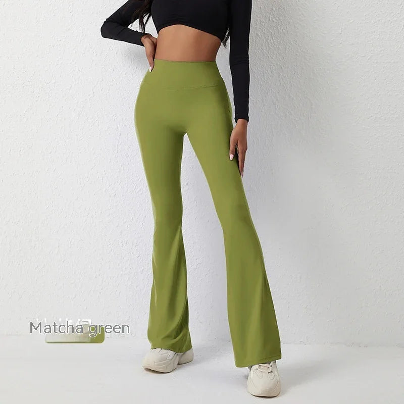 Woman wearing high-waisted matcha green flare pants with black crop top and white sneakers