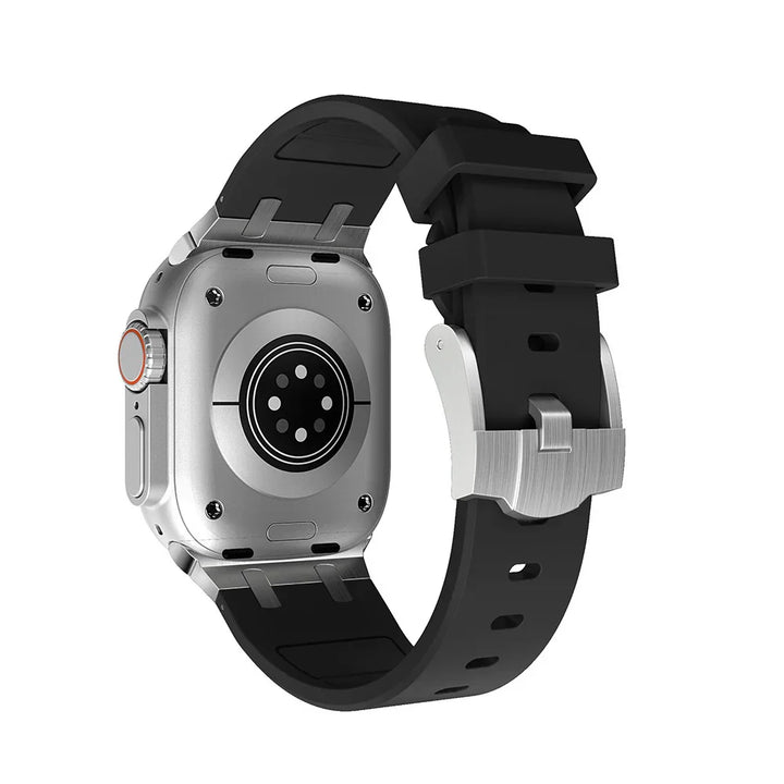 Back view of a silver smartwatch with black silicone band and metal buckle on white background