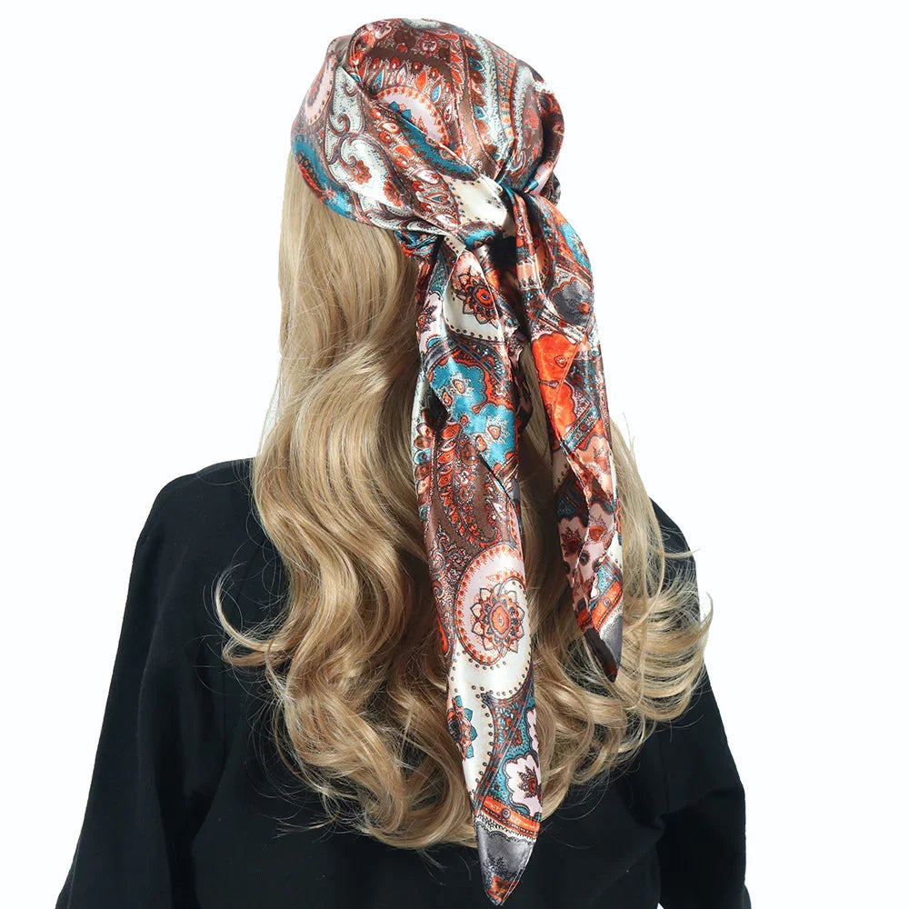 Back view of blonde hair tied with colorful paisley patterned silk scarf and black top