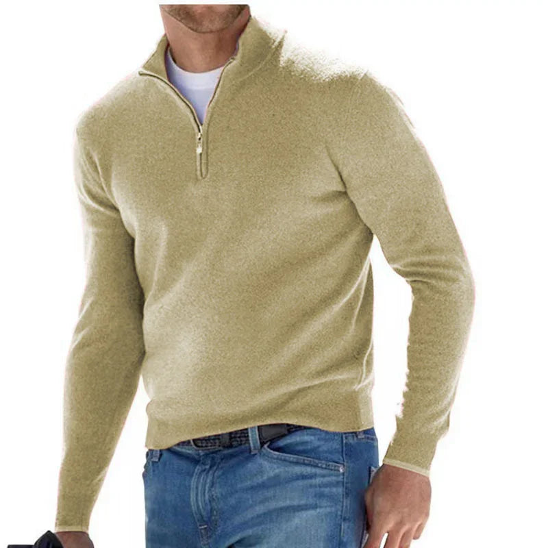 Men's beige quarter-zip sweater paired with blue jeans, casual winter outfit